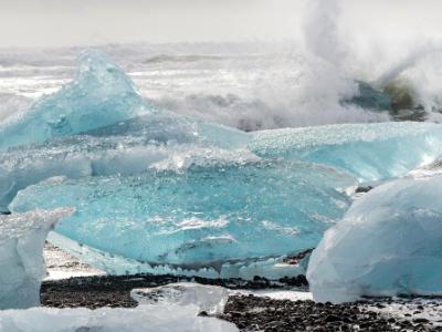 Waves Crash on Blue Icebergs